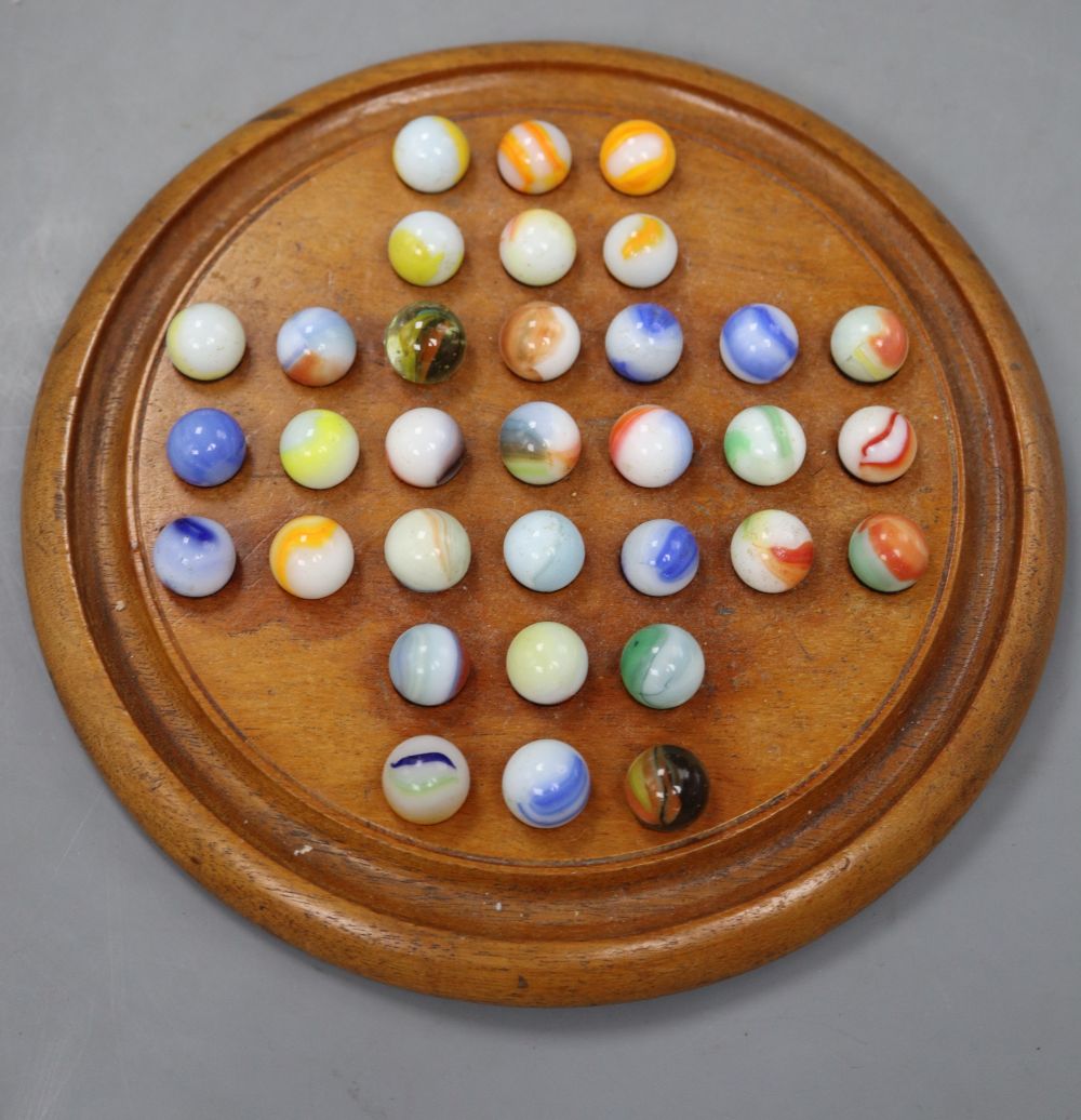 A Victorian mahogany solitaire board and set of marbles